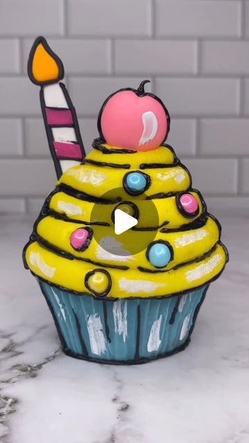 Rachel Lindsay on Instagram: "Cartoon cupcake 🩵💛💗🖤 It is all edible 🥳😊 I used @colour.mill oil colours for my chocolate and my cake batter. The cherry and the candle are made from fondant and the black lines are piped using black candy melts 🖤 This was way harder than I thought it would be 🫣 #cupcake #cupcakeart #cartooncake #cakedecorating #cakedbyrach #cakeart #isitcake" Raye Escapism, Cartoon Cupcakes, Rachel Lindsay, Instagram Cartoon, Black Candy, Cartoon Cake, Cupcake Art, Cake Trends, Candy Melts