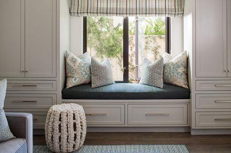 White drawers, adorned with polished nickel pulls and topped with a black cushion and blue and gray pillows, are positioned beneath a window dressed in a blue striped roman shade. Ceiling Cabinets, Bedroom Window Seat, Built In Window Seat, Floor To Ceiling Cabinets, Bedroom Built Ins, Window Seat Design, Transitional Bedroom, Bedroom Closet Design, Bedroom Bed Design