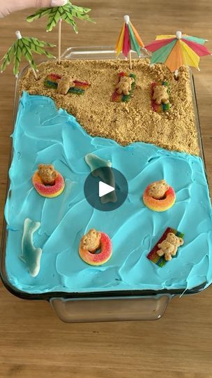 28K views · 368 reactions | Beach Jello Poke Cake! 🏖️

This was such an easy treat to make and my kids always love it! 

Ingredients:
1 box white cake mix + prep ingredients 
1 3oz box blue jello
1 cup boiling water
1 can white vanilla frosting 
1 can blue vanilla frosting 
1/2 cup graham cracker crumbs 
Peach rings 
Teddy grahams
Sour belts 
Gummy sharks 
Beach umbrellas 

1. Prepare the cake mix according to directions in the box, then allow to cool to room temperature.
2. Combine the box of jello with the boiling water and stir until the sugar has dissolved. Allow to cool but not set.
3. Poke holes all over the baked cake with a fork, then pour on the jello.
4. Spread the white frosting over half the cake, then blue over the other half.
5. Decorate with the candy, teddy grahams, and be Poke Cake Jello, Sour Belts, Blue Jello, Easy Treats To Make, Teddy Grahams, White Frosting, Poke Cake, White Cake Mixes, Vanilla Frosting