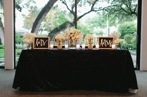 Bethany and Kevin sat at a sweetheart table set against the oversize window backdrop, where they exchanged vows. It had black linens topped with white flower arrangements and gold-framed signs with "Mr." and "Mrs." in whimsical gold calligraphy. Black And Gold Sweetheart Table Wedding, Black And Gold Sweetheart Table, Wedding Brunch Decorations, Black White And Gold Wedding Reception, Black And White Sweetheart Table, Gold Sweetheart Table, Wedding Entry Table, Bridesmaid Brunch Invitations, Visionary Board