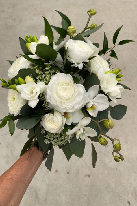 White ranunculus, white freesia and orchid wedding bouquet Freesia Wedding Bouquet, Ranunculus White, Orchid Bouquet Wedding, White Freesia, Prom Bouquet, Ranunculus Bouquet, Fern Wedding, Reception Tablescapes, White Ranunculus