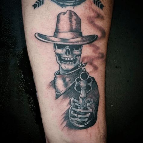 Maybe we’re being stereotypical, maybe we just wish we were throwing back beers on the ranch with the boys, watching the horses gallop into the sunset while reminiscing about the girl who caused our Achy Breaky Heart. Nothing like a little ink to ease the pain. Tattoo by @berserk_tattoos #inked #tattoo #cowboy #skull #gun #smoke #realism #skeleton Country Bicep Tattoo, Hillbilly Tattoo Ideas, Country Western Tattoos Men, Western Cowboy Skeleton Tattoo, Cowboy Skull Tattoo Design, Country Skeleton Tattoo, Cowboy Hand Tattoo, Cowboy Western Tattoos For Men, Whiskey Tattoo Ideas