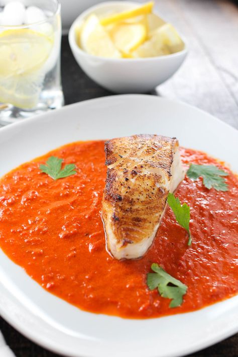 A perfectly seared Chilean sea bass with a spicy red pepper sauce. Red Pepper Coulis Recipe, Sea Bass Recipes, Pescetarian Recipes, Roasted Red Pepper Sauce, Healthy Meats, Cold Sandwiches, Red Pepper Sauce, Yummy Seafood, Fish Recipes Healthy