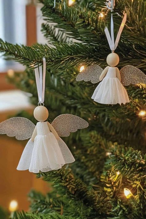 Wooden Bead and Tulle Angel with Laser-Cut Wings Wood Bead Angel Ornaments, Angel Making Crafts, Wood Angel Ornaments Diy, Wooden Bead Angel Ornaments, Ribbon Angels Diy, Angel Diy Ornaments, Making Angels Crafts, Angel Faces For Crafts, Diy Angel Ornaments How To Make