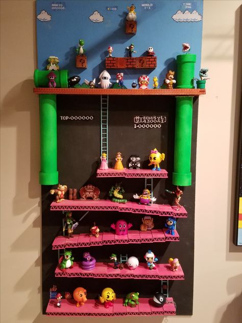 This is a 4-foot homemade shelf made of wood and PVC pipe modeled after the Classic Donkey Kong and original Super Mario Bros. The figures are mini Pop Vinyl and World of Nintendo action figures. Super Mario Shelf, Mario Shelf, Homemade Shelf, Donkey Kong Party, Mario Bedroom, Homemade Shelves, Nintendo Room, Mario Wall, Super Mario Room