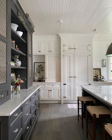 This kitchen is a floor-to-ceiling show stopper! And how about that dark built in?! Click our link to check out our kitchen Before & Afters! via jeanstofferdesign on Instagram #interiores #kitchenenvy #kitchenfloor #marbleisland #kitchenlighting #kitchenbuiltin #builtin #kitchendecor #flutedceiling #whitekitchen #kitchenmix #blackandwhitekitchen #allaboutthemix #kitchenstools #kitchenpendants #woodfloor #woodenfloor #kitchencounter #marblecounter #marblecountertop #countertop #kitchencountertop Modern Refrigerator, Jean Stoffer Design, Jean Stoffer, Modern Classic Home, Baths Interior, Show House, Junior League, Traditional Interior Design, Farmhouse Kitchen Design