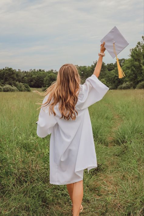 Senior Pic Prop Ideas, White Cap And Gown Graduation Pictures, Senior Pictures In Front Of High School, Graduation Field Pictures, Female Senior Pictures Poses Cap And Gown, Senior Pics With Props, College Graduation Pictures Outdoors, Spring Senior Photoshoot Ideas, Senior Photoshoot Ideas Cap And Gown