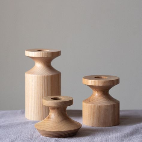 Each contemporary candlestick is turned from a single piece of British Ash, known for it’s striking grain and finished in a hardwearing wax and oil blend Product dimensions (approx) - Height 11.5cm Diameter 6cm Central hole fits a standard 7/8ths inch dinner candle. FEATURES CONTEMPORARY WOODEN TABLEWARE BY SELWYN HOUSE HANDMADE IN DERBYSHIRE FROM BRITISH-GROWN TIMBERS TRADITIONAL CRAFT METHODS Lathe Projects Woodturning, Candlestick Wood, Turned Candle Holders, Turned Candlesticks, Wooden Candle Stand, Woodturning Art, Wooden Candlestick, Wooden Tableware, Dinner Candle