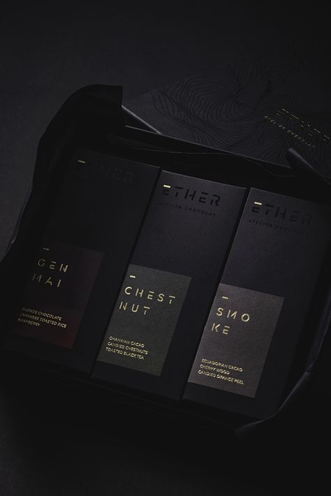 Design Stack - Ether - World Brand Design Society / Design Stack developed the brand identity for Ether Atelier Chocolat, an exclusive range of artisanal chocolates. Black Gold Packaging Design, Black And Gold Packaging Design, Luxury Chocolate Branding, Black And Gold Packaging, Chocolate Bar Design, Black And Gold Aesthetic, Cookies Branding, Chocolate Packaging Design, Chocolate Recipes Homemade