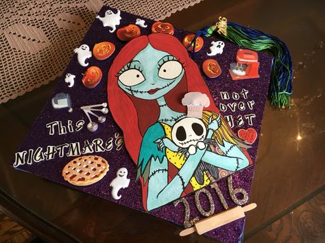 ' This NIGHTMARE'S not over YET ' 2016 graduation cap . my original design .purple glittered paper.  hand drawn . acrylic painted . w/baking themed stickers to emphasize future career in the making . inspired by Tim Burton's ' The Nightmare Before Christmas ' . Spooky Graduation Cap, Nightmare Before Christmas Graduation Cap, Tim Burton Graduation Cap, Nightmare Before Christmas Grad Cap, Graduation Preschool, Creative Graduation Caps, Graduation Hats, Graduation Cap Decoration Diy, High School Graduation Cap