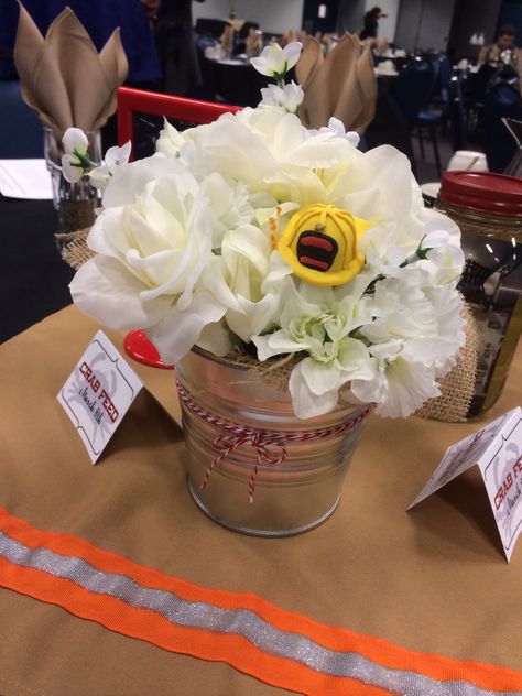 Fire department banquet - dollar store flower stems & floral foam, scraps of burlap, Sculpey clay helmets hot glued on the cutoff wire flower stems, baker's twine. #firemen #firefighter #banquet Fire Company Banquet Ideas, Fire Department Banquet Decorations, Fire Department Banquet, Firefighter Banquet, Jar Wedding Centerpieces, Mason Jar Wedding Centerpieces, Fire Department Christmas, Fireman Wedding, Firefighter Retirement