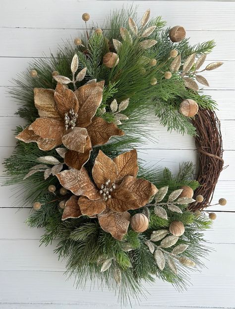 This wreath is a lovely neutral color scheme that stand out in Christmas and Winter decor. The combination of the winter greenery, caramel and gold poinsettias, gold iced berries, golden brown velvet balls and gold glittered leaves give this wreath a monochromatic style that would stand out on the front door or as wall decor in the foyer or above the fireplace mantel.  This grapevine wreath is handmade using lifelike faux greenery and florals. This wreath is 25 high and 19" inches wide.  ❤️ You can visit my shop at www.etsy.com/shop/wreathsonwindsor to see my other listings and if you favorite my shop you'll see new listings as they post. Get a 15% off coupon! https://mailchi.mp/f27efc482451/etsy-email (Copy and paste this link into your browser to receive the welcome email with your coupo Green And Brown Christmas Decor, Gold Front Door, Green And Gold Wreath, Xmas Arrangements, Colorful Christmas Decorations, Monochromatic Style, Winter Wreath Diy, Decorated Wreaths, Winter Greenery