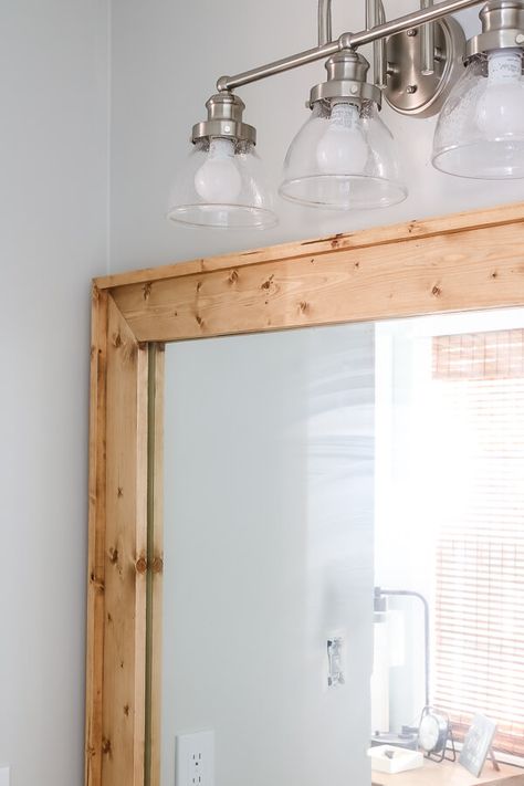 Wood Trimmed Mirror Bathroom, Diy Frame Bathroom Mirror With Clips, Frame A Bathroom Mirror With Clips, Diy Farmhouse Mirror Bathroom, Diy Wood Framed Mirror Bathroom, Frame A Frameless Mirror, Framing A Bathroom Mirror With Wood, Contractor Grade Mirror Makeover, Diy Frame For Wall Mirror