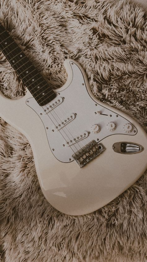 Cream electric guitar  on bed. Cream Electric Guitar, Aestetic Blanc, Beige Electric Guitar, White Electric Guitar Aesthetic, Guitarist Aesthetic, Electric Guitar Aesthetic, Brown Electric Guitar, Guitar Modes, White Electric Guitar