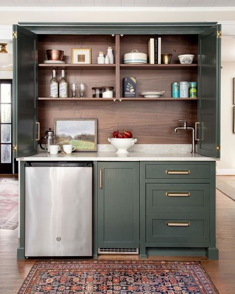 Georgia Hoyler on Instagram: “I adore this lovely green wet bar with stained woodgrain inside! That small vintage rug defines the space and seals the deal for me.…” Hidden Bar Cabinet, Small Wet Bar, Kitchen Wet Bar, Hidden Bar, Small Sink, Coffee Bar Home, Green Cabinets, Wet Bars, Wet Bar