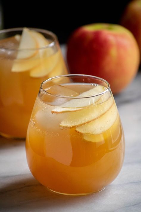 This easy, spiced and delicious Apple Pie Cocktail combines Vanilla Vodka, Fall Spiced Simple Syrup, Apple Cider and Ginger Beer for an easy and delicious drink perfect for those cozy fall nights! Make a few or a batch with just a few minutes and a few simple ingredients! Garnish this apple pie drink recipe with fresh apple slices and cinnamon sticks to make the drinks extra special! Easy Drinks Alcohol Recipes Vodka, Simply Apple Cocktail, Apple Cider Carmel Vodka Fall Drinks, Cold Apple Cider Alcohol Drinks, November Drinks Alcohol, Vodka Apple Cider Fall Drinks, Apple Cider Alcohol Drinks, Apple Vodka Drinks, Apple Cider Alcoholic Drink