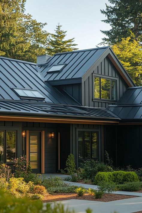 Quality Roofing2 Modern black farmhouse with sleek metal roof, large windows, and beautiful landscaping in a forest setting. | Sky Rye Design Modern Black Farmhouse, Slate Roof House, Modern Skylights, Black Metal Roof, Metal Roof Houses, Sustainable House Design, Zinc Roof, Skillion Roof, Steel Siding