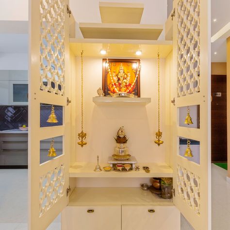 Frosty White Mandir Design With Perforated Door And Bells | Livspace White Mandir Design, Modern Pooja Unit, Low Floor Bed, Pooja Unit, Single Door Design, Mandir Design, Floor Bed, Pooja Room, White Floors