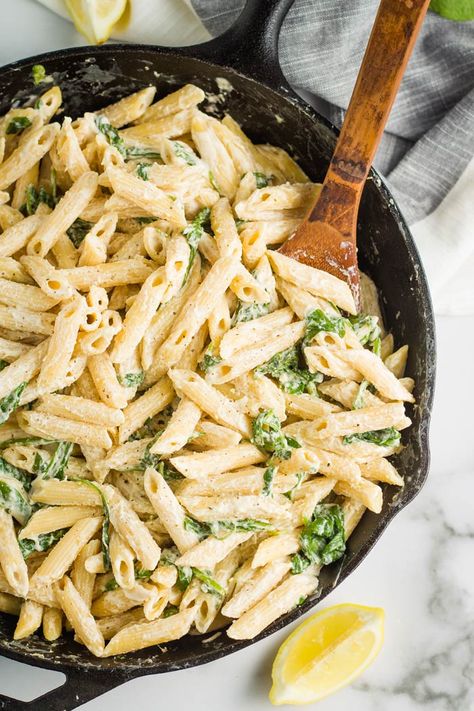 Creamy spinach pasta in a large cast iron pan with a wooden spoon. Creamy Spinach Pasta, Spinach Pasta Recipe, Italian Sausage Recipes Pasta, Quick Vegan Dinner Recipes, Creamy Sausage Pasta, Spinach Pasta Recipes, Carrot Dogs, Spinach Pasta, Creamy Spinach