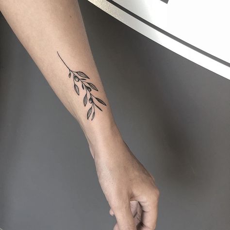 Minimalist Olive Branch Tattoo, Branch Tattoo Wrist, Olive Leaves Tattoo Design, Olive Branch Tattoo Mens, Olive Tree Tattoos, Olive Tattoo, Olive Branch Tattoo, Meaningful Wrist Tattoos, Simple Tattoos For Women