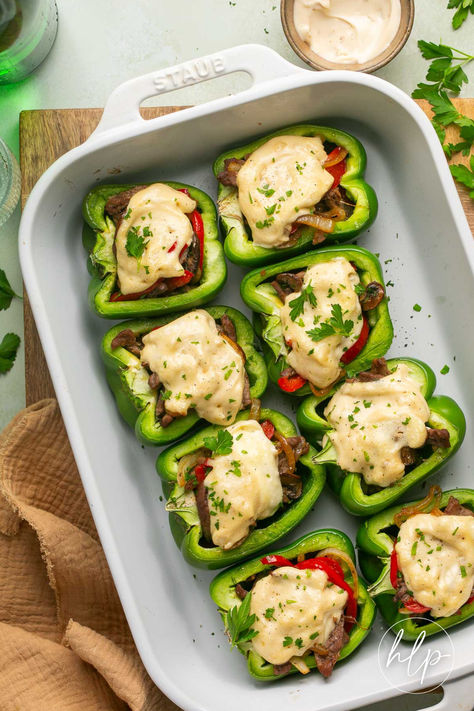 a baking dish filled with cheesesteak stuffed peppers topped with Mac's Awesome Sauce Green Peppers Stuffed, September Meals, Pepper Recipes Healthy, Philly Cheesesteak Stuffed Peppers, Steak Mushrooms, Whole30 Meals, Dairy Free Sauces, Cheesesteak Stuffed Peppers, Paleo Dinners