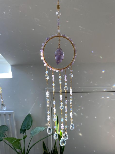 This Large Suncatcher, handmade lovingly by me ~  made with the intention of supporting its keeper deep healing and intuition.  size: approx 51cm / 20" long  Made with Amethyst gemstones and glass. I have arranged the components into patterns and shapes that will capture the light beautifully, and cast mesmerising reflections and rainbows around your space.  The suncatcher is adorned with delicate details, such as the inclusion of tiny, sparkling glass beads that add an extra dimension of shimme Crystal Hangers, Large Suncatcher, Crystal Hanger, Wind Art, Deep Healing, Rainbow Maker, Crystal Suncatchers, Artistic Inspiration, Handmade Beaded Jewelry