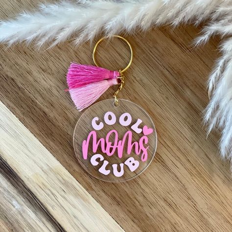 "Our Cool Moms Club keychain measures 2\"x2\" and features \"Cool Moms Club\" in monochromatic pink with a heart detail. Add to cart, checkout and voila! Enjoy your new beautifully handcrafted keychain! ABOUT KEYCHAIN: -Keychains measures 2x2\" -Printed single-sided with premium, permanent vinyl for durability -All hardware is gold -Keychain is made from acrylic, charms made from acrylic and enamel -Waterproof, lightweight, durable, and easy to carry around! SHIPPING: Orders are shipped using US Mothers Day Acrylic Keychain, Heart Acrylic Keychain, Acrylic Keychain Ideas, Cricut Keychains, June Design, Monochromatic Pink, Cool Moms Club, Gold Keychain, Custom Keychains