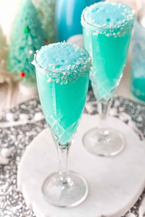 A gorgeous hue of blue, a Jack Frost mimosa, with its frosty rim of coconut,  is a spectacular addition to your brunch or holiday party. Blue Alcoholic Drinks Aesthetic, Blue Mimosa, Christmas Drinks Alcohol Recipes, Gel Wax Candles, Christmas Party Drinks, Christmas Drinks Recipes, Christmas Drinks Alcohol, Winter Cocktail, Coconut Drinks