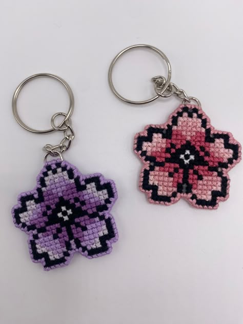 This is a handmade double sided cross stitched key chain. The cherry blossom contains a gradient in the color selected. If you would like a custom color, please feel free to message me!  Please feel free to reach out to me if you have any questions or if there is a problem with your order! Cross Stitch Keyring Patterns, Keychain Cross Stitch, Cross Stitch Keyring, Hello Kitty Cross Stitch Patterns, Sakura Cross Stitch, Cherry Blossom Cross Stitch, Hello Kitty Cross Stitch, Mini Cross Stitch Patterns, Cross Stitch Keychain