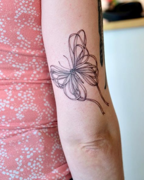 Really loved doing this ribbon butterfly from my flash on Serena 🎀 🦋 We found the perfect placement to add some flow to her existing tattoos 🥹 <3 <3 #tattoo #tattoideas #finelinetattoo #portlandtattoo #portlandtattooartist #ribbontattoo #butterflytattoo #birdhousetattoo Butterfly Ribbon Tattoo, Ribbon And Butterfly Tattoo, Purple Ribbon Butterfly Tattoo, Ms Ribbon Butterfly Tattoo, Butterfly With Pink Ribbon Tattoo, Butterfly Awareness Ribbon Tattoo, Pearl Tattoo, Portland Tattoo, Ribbon Tattoos