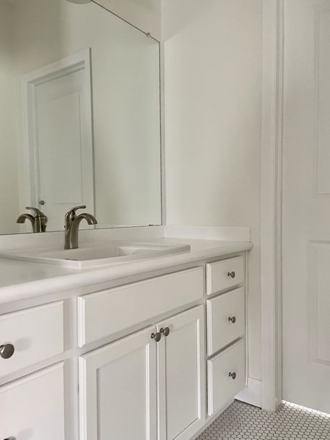 This guest bathroom features an all-white color palette with SW Alabaster walls and SW Pure White cabinets. Sw Alabaster Walls, Pure White Cabinets, Alabaster Walls, Sw Pure White, Sw Alabaster, Neutral Interior Paint Colors, Sherwin Williams Alabaster, Alabaster Color, All White Bathroom