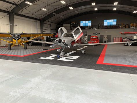 Ribtrax is the perfect complimentary flooring in this hangar. Taking this space to a new level. #Hangar #Aircraft #HangarFlooring #Swisstrax #Ribtrax #Cirrus Airplane Hangar Man Cave, Aircraft Hanger House, Hangar Homes Floor Plans, Airplane Hangar Design, Hangar Decor, Private Hangar, Hangar Architecture, Aircraft Hangar Design, Hanger Homes