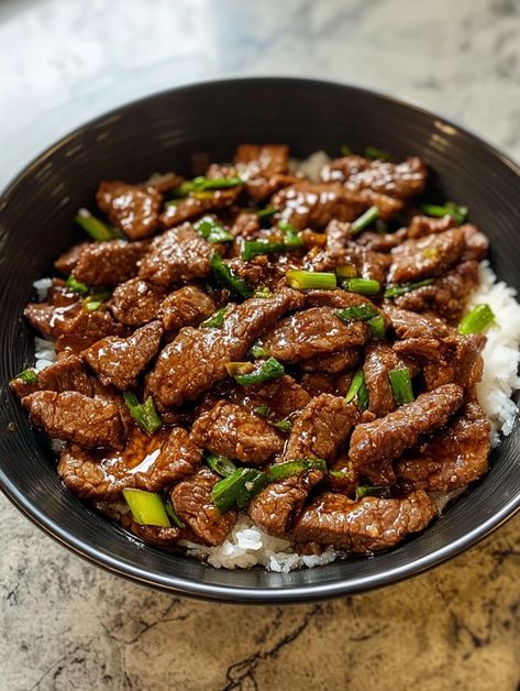 This Simple Mongolian Beef recipe is a deliciously savory dish that’s perfect for a quick weeknight dinner. With tender slices of flank steak coated in a sweet and savory sauce made from soy sauce, brown sugar, garlic, and ginger, it's sure to satisfy your cravings. Mongolian Beef Recipe Gluten Free, Asian Style Steak, Lean Steak Recipes, Asian Steak Recipes, Flank Steak Recipes Oven, Angus Beef Recipes, Asian Steak, Mongolian Beef Recipe, Steak And Rice