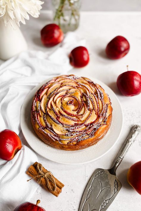 This apple rose cake is soft, tender and is topped with lots of sliced red apples arranged to form a rose! It's finished off with warm honey syrup and a light dusting of icing sugar. A stunning dessert for your table this Autumn! Rose Cake Recipe, Apple Rose Tart, Baking Competition, Gourmet Apples, Apple Dishes, Apple Rose, Thanksgiving 2023, Springform Pan Cake, Shana Tova