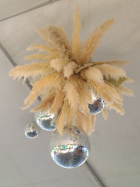 Pampas grass and disco balls combined to make the perfect centerpiece in this tent top for the boho glam wedding. Pampas Grass Disco Ball, Pampas And Disco Ball Wedding, Rustic Glam Decor Wedding, Pampas Chandelier, Boho Disco Party, Rustic Glam Decor, Country Prom, Boho Glam Wedding, Glam Chandelier