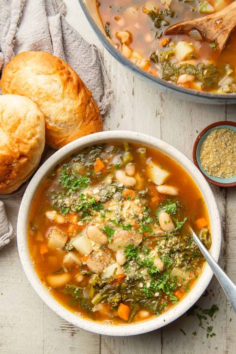 This broccoli rabe soup is comforting, hearty, and full of flavor! Made with potatoes and white beans in a garlicky broth, a big bowl of this makes a delicious meal on a chilly day! #HalfYourPlate #Broccoli #Soup #Vegetarian #VegetarianSoup #Vegan #VeganSoup Escarole Soup, Soup Vegetarian, Vegan Parmesan Cheese, Broccoli Rabe, Broccoli Soup, Diced Potatoes, Vegetarian Soup, Butter Beans, Cannellini Beans