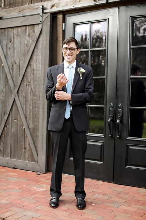 Black groom's suit with dusty blue tie Dusty Blue Tie, Wedding Venues In Florida, Groom's Suit, All Inclusive Wedding, Wedding Cross, Florida Wedding Venues, Swim Team, Groom Suit, Floral Cake