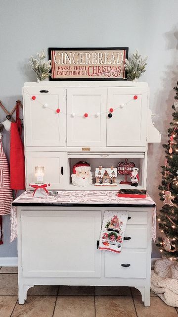 Desiree || Home & Garden on Instagram: "The Hoosier is decorated for Christmas and I am obsessed! Watch until the end for a quick peak at the kitchen Christmas tree fully decorated. I'll share that tomorrow! You guys are going to love it. #christmasinspiration #hoosiercabinet #decoratingforchristmas #christmasdecor #christmasdecorating #mymichaels #hobbylobbychristmas #gingerbread #gingerbreadhouse #christmaskitchen" How To Decorate A Hoosier Cabinet, Hoosier Cabinet Decorating Ideas, Kitchen Christmas Tree, Remodeling House, Hoosier Cabinets, Hoosier Cabinet, Hobby Lobby Christmas, Kitchen Christmas, Cabinet Decor