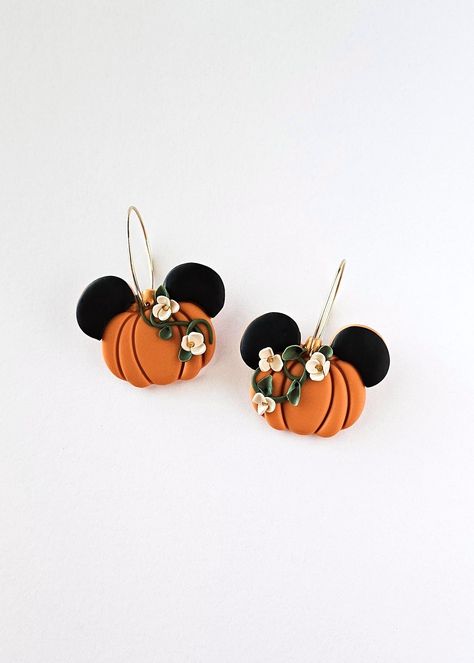 Get ready for the pumpkin season this Fall in these botanical pumpkins with adorable mouse ears. The earrings feature a vibrant orange pumpkin hue and are elegantly styled as hoop dangles with secure latch back closures. Perfect for adding a touch of whimsy to any outfit! 🎃🐭 Each item is designed and crafted by me with passion and care. As the creator, designer, and artist, I take pride in every piece I make. Please keep in mind that, while I hold myself to high standards for quality, handmade items may have slight variations and imperfections that make them one-of-a-kind. So embrace the charm and character that comes with each handmade creation! Follow @clayunico on instagram! Care: All earrings are made of polymer clay, which is a durable and water-resistant material. Maintain the long Disney Clay Earrings Diy, Polymer Clay Fall Ideas, Pumpkin Polymer Clay Earrings, Disney Polymer Clay Earrings, Halloween Earrings Diy, Pumpkin Clay Earrings, Halloween Clay Earrings, Pumpkin Clay, Thanksgiving Earrings