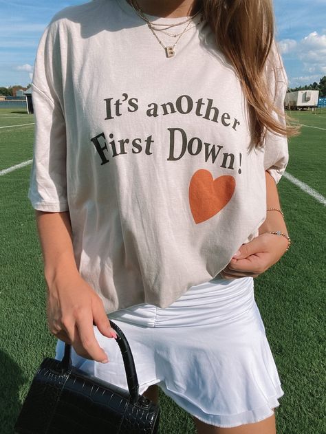 ☆Our "First Down" tee is a must have for football season! Stock up on all our gameday items to cheer on your favorite team. This tee comes in red, orange, purple, and blue to fit any team! Cotton Blend light grey tee with varying colored designs Materials may have natural variations Colors may vary from different viewing devices Comes Regular Length ☆For a cropped, distressed, or acid washed look add customizations to the notes section at checkout. ☆Please note: This item is a handmade item and Fall Graphic Tee, Football Graphic Tee, First Down, Fits Clothes, Tshirt Ideas, Football Tees, Game Day Shirts, Vintage Couture, Medium Purple