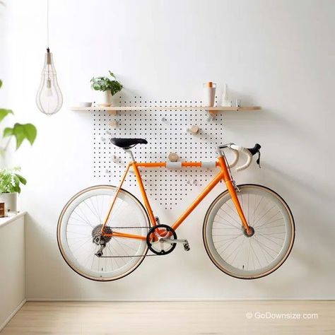 Designed as a pegboard, this rack offers a grid of holes that allow for flexible and adjustable bike storage. Office Bike Storage, Mudroom Bike Storage, Bike Rack Apartment, Apartment Bike Rack, Bicycle Display Ideas, Hanging Bicycle On Wall, Bicycle Storage Ideas Small Apartments, Bike Display Ideas, Indoor Bike Storage Ideas