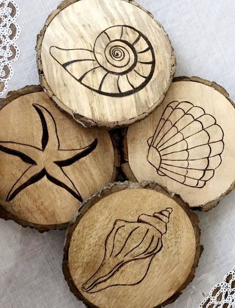 Coastal Coasters #nautical #shells #seashells #madetoorder #original #localart #capemay #cmnj #beach #rustic #weddinggifts #home #simple #farmhouse #beachcottage #woodburning #creativecreations Wood Burning Beach Scene, Beach Wood Burning, Beach Wood Burning Ideas, Coaster Wood Burning, Simple Pyrography Designs, Simple Woodburning Designs, Wood Burning Coasters Ideas, Wood Engraving Designs, Wood Burning Coasters