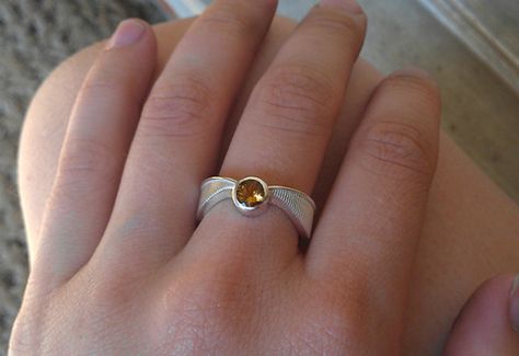 A Harry Potter engagement ring that looks like a Golden Snitch, but is still subtle enough that it doesn't scream cosplay? AMAZING. Golden Snitch Hair Piece, Golden Snitch Ring Box, Harry Potter Engagement Ring, Horcrux Ring, Golden Snitch Earrings, Golden Snitch Jewelry, Harry Potter Engagement, Wizard Jewelry, Harry Potter Snitch