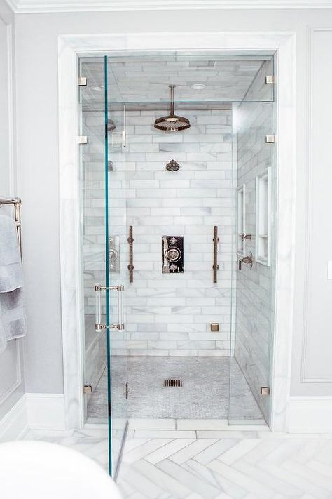 Walk-in steam shower with staggered honed marble tiles, multiple side by side shower heads and a mosaic marble floor. Steam Room Shower, Bathroom Shower Panels, Honed Marble, Steam Showers Bathroom, Bad Inspiration, Master Bath Remodel, Steam Shower, Bathroom Remodel Shower, Steam Showers