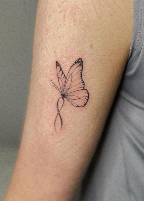 100 Unique Butterfly Tattoo Ideas (Best Butterfly Tattoos) - The Trend Scout Butterfly Ribbon Tattoo Small, Butterfly Tattoo With Ribbon, Butterfly Awareness Ribbon Tattoo, Butterfly With Pink Ribbon Tattoo, Ribbon And Butterfly Tattoo, Purple Ribbon Butterfly Tattoo, Miscarried Butterfly Tattoo, Butterfly With Ribbon Tattoo, Cancerian Butterfly Tattoo