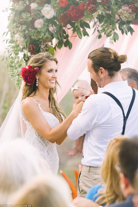 That look of love: The Hills vet wore a red flower behind her ear Flower Behind Ear Hair, Red Flower In Hair, Flower Behind Ear, Celebrity Brides, White Lace Gown, Floral Wedding Hair, Nola Wedding, Audrina Patridge, Celebrity Bride