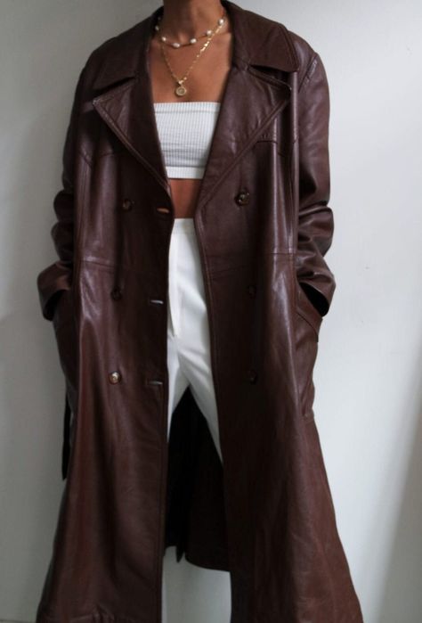 Indulge in timeless elegance with our Women's Long Trench Coat in Vintage Brown, a nod to the iconic Boho styles of the 90s. Crafted from sumptuous sheepskin leather, this maxi-length overcoat offers luxurious comfort and durability. Featuring a double-breasted design, it seamlessly merges vintage charm with contemporary sophistication. Perfect for spring, its soft and supple leather ensures a comfortable wear experience. Elevate your wardrobe with this statement piece that exudes confidence and Long Brown Trench Coat, How To Style Leather Coat, Long Brown Leather Coat Outfit, Leather Coat Outfits Women, Long Brown Leather Jacket Outfit, Brown Leather Trench Coat Outfit, Brown Leather Coat Outfit, Long Leather Coat Outfit, Quite Luxury Outfit