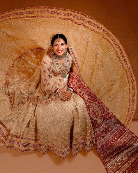 A Fairytale Come to Life - Radhika Merchant wears Abu Jani Sandeep Khosla for her wedding ceremony to Anant Ambani. Radhika’s ensemble is Abu Sandeep�’s intricate interpretation of ‘Panetar’ - the Gujarati tradition of brides wearing red and white. The ivory Zardozi cut-work ensemble consists of a trailing ghagra layered with a second detachable trail, a 5 meter head veil and a tissue shoulder dupatta. The ghagra glitters with three borders of red, Its workmanship is the finest amalgamation ... Radhika Merchant Wedding, Radhika Merchant, Anant Ambani, Jewel Wedding, Wedding Lehenga, Lehenga Designs, July 12, Bridal Lehenga, Wedding Looks