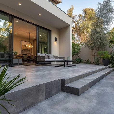 Backyard Patio Modern, Poured Concrete Patio Ideas Landscape Design, Patios Ideas Backyard Pavers, Porcelain Patio With Steps, Black Stone Patio, Contemporary Concrete Patio, Outdoor Patio Concrete Ideas, Elevated Patio Ideas, Modern Concrete Patio Ideas