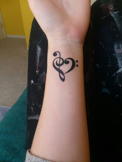 Got this bass and treble clef heart at Ironhorse Tattoo!! Music Tattoo Treble Clef, Treble Clef And Bass Clef Tattoo, Bass Clef Treble Clef Heart Tattoo, Treble Bass Clef Tattoo, Treble And Bass Clef Heart, Musical Heart Tattoo, Heart With Music Notes Tattoo, Tattoo Treble Clef, Treble Bass Clef Heart Tattoo